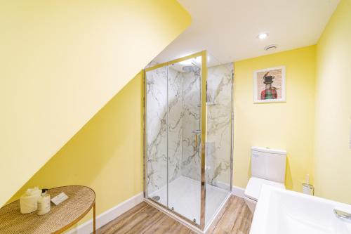 a bathroom with a shower and a toilet at Gardener’s Cottage with Hot Tub in Blairgowrie