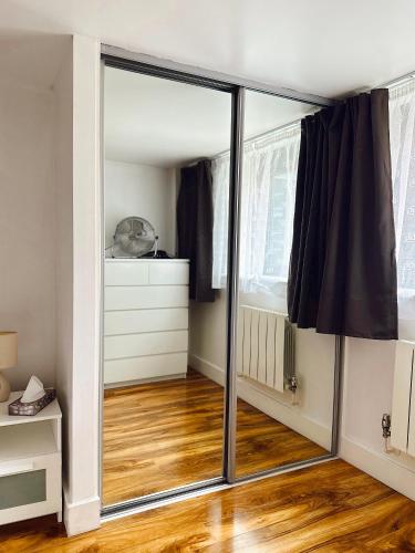 a sliding glass door in a room with a wooden floor at Canary Wharf - Luxury Apartments in London