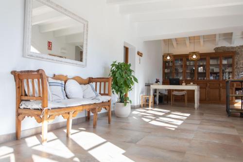a living room with a bench and a mirror at Agroturismo Son Vives Menorca - Adults Only in Ferreries