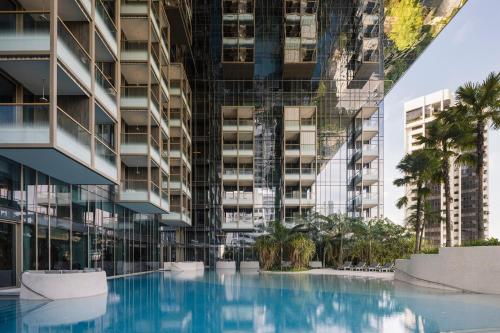 a swimming pool in front of a tall building at Pan Pacific Orchard in Singapore