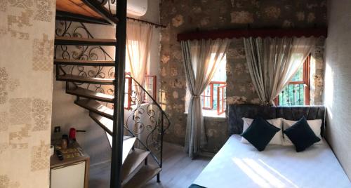 a bedroom with a bunk bed and a spiral staircase at grand friends in Antalya