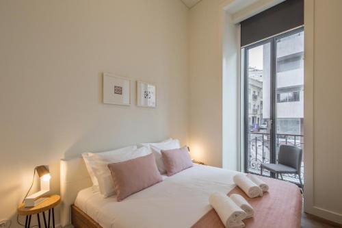 a bedroom with a bed and a large window at Lisbon Marquês de Pombal, TTLDL42 in Lisbon