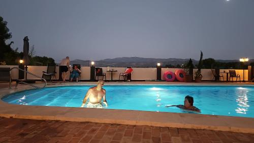 two people in a swimming pool at a hotel at B&B Finca la Yuca "Un paraíso en Ontinyent" in Ontinyent