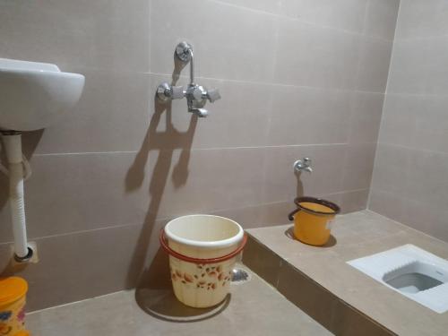 a bathroom with a toilet and a sink at SHI's Shambhavi homestay -On the way to Isha, Maruthamalai in Coimbatore