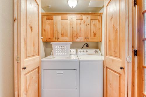 a washer and dryer in a kitchen with wooden cabinets at #404 Grand Lodge South Penthouse in Government Camp