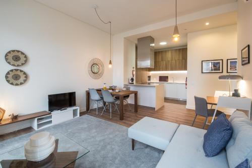 a living room and kitchen with a couch and a table at Lisbon Marquês de Pombal, TTLDL42 in Lisbon