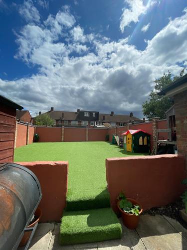 a backyard with green grass and a playground at Mitcham Let 11 in Mitcham