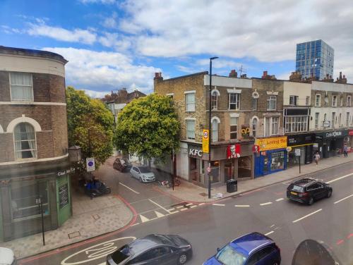 a city street with cars parked on the street at Beautiful and homely accommodation, Archway in Islington near Camden town in London