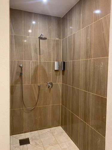 a bathroom with a shower with a shower head at Libau Apartment in Liepāja