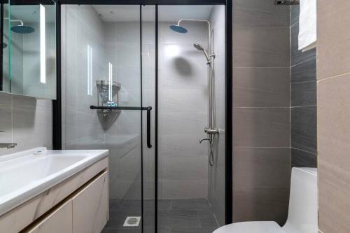 a bathroom with a shower and a toilet and a sink at Laurel Hill Suites 1-Bed By YourHost UpperHill Nairobi in Nairobi