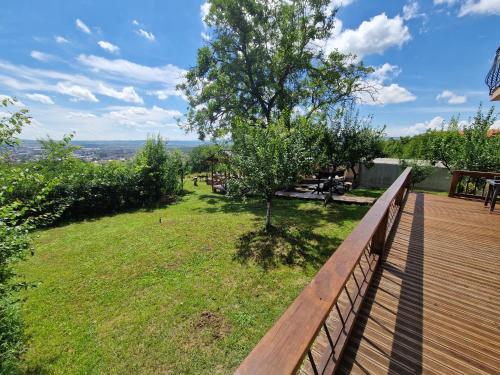 a wooden deck with a view of a yard at Bella Vista Turda in Turda