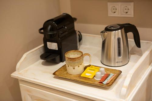 a counter with a coffee maker and a cup on it at BELLA VITA boutique hotel lefkada in Lefkada Town