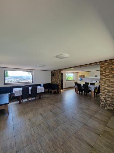 a dining room with tables and chairs and a brick wall at Bella Vista Turda in Turda