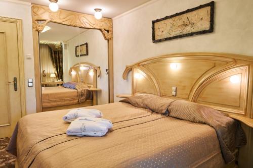 Postel nebo postele na pokoji v ubytování Grand SPA Lietuva Serviced Apartments Dzūkija