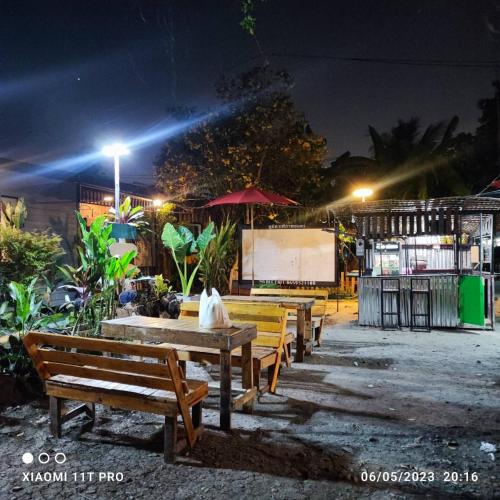a group of benches in a park at night at Do Dee cafe in Bangkok