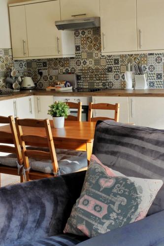 a living room with a couch and a wooden table at Cosy One Bed Barn Conversion Donington Park East Midlands Airport in Derby
