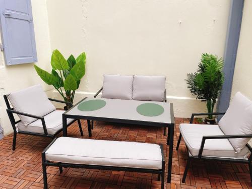 - une terrasse avec 2 chaises et une table basse dans l'établissement Villa muguette - coeur de Vichy- RDC-véranda sur la terrasse, à Vichy