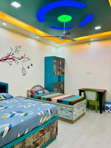 a bedroom with a bed and a table and a ceiling at Smart Stays - MMMUT College - GKP Airport in Gorakhpur