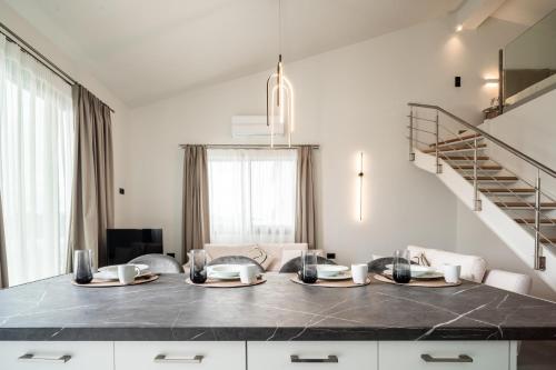 a kitchen with a table with two plates on it at Vathy Villas in Preveza