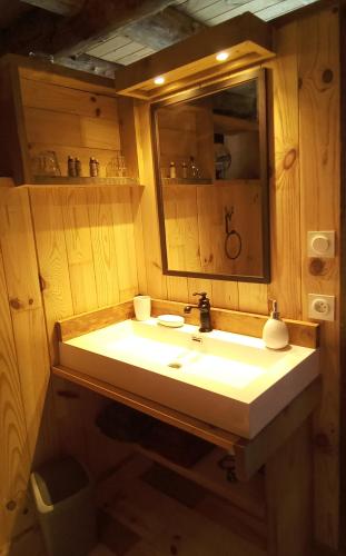 a bathroom with a sink and a mirror at L' Auberge du château in Génos