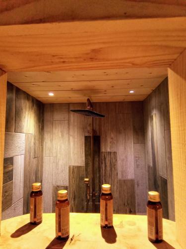 a room with four bottles on a table with a ceiling at L' Auberge du château in Génos
