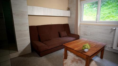 a living room with a couch and a coffee table at La Sapinière St Lary Soulan in Saint-Lary-Soulan