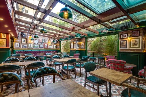 a restaurant with tables and chairs and a glass ceiling at Gordion Hotel - Special Class in Ankara