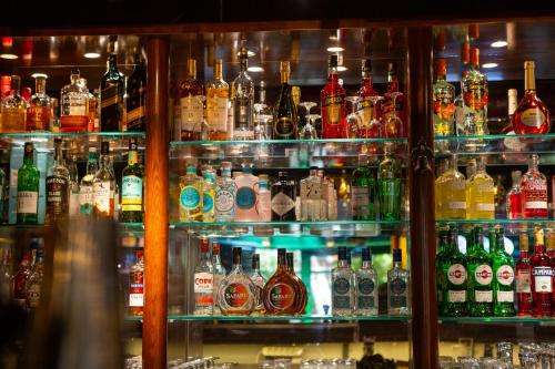 a shelf filled with lots of bottles of alcohol at Gordion Hotel - Special Class in Ankara
