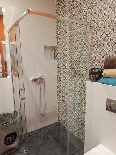 a shower with a glass door in a bathroom at Slaska 12 in Gdańsk