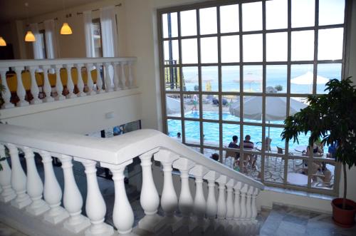 a staircase in a house with a view of a pool at Mitsis Belvedere in Benitses