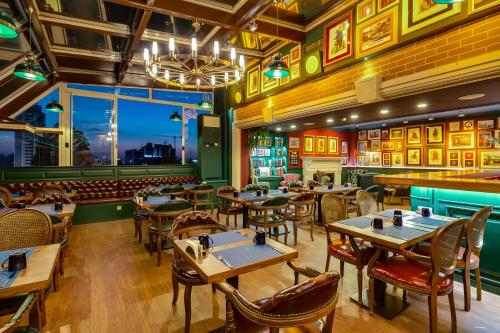 a restaurant with tables and chairs and a view of the city at Gordion Hotel - Special Class in Ankara