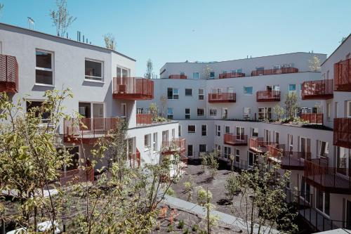 a row of apartment buildings with a courtyard at Homewell Apartments Game and Movie in Poznań