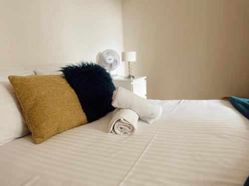 a stuffed animal sitting on top of a bed at Canary Wharf - Luxury Apartments in London