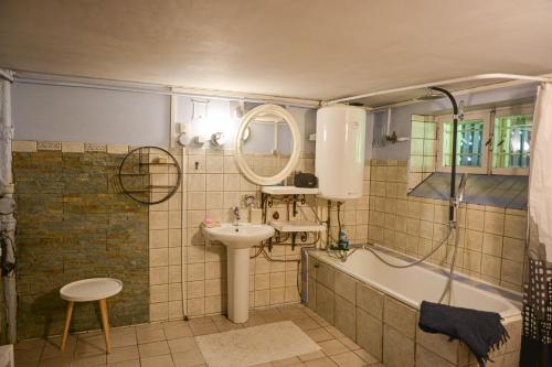 a bathroom with a tub and a sink and a bath tub at Sirbi House in Tallinn