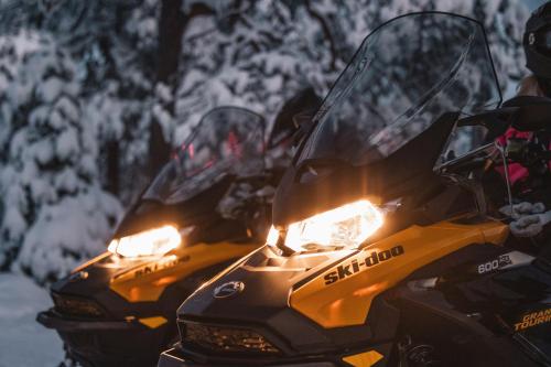 two motorcycles parked in the snow with their lights on at Nova Galaxy Village in Rovaniemi