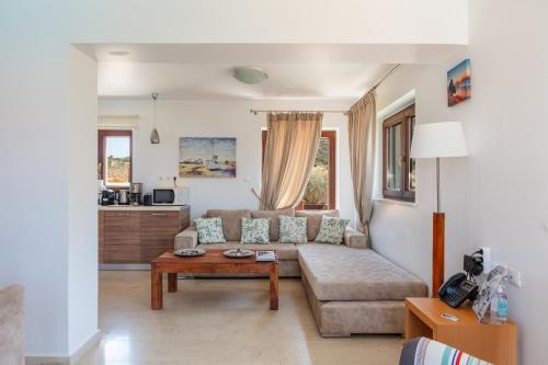 a living room with a couch and a table at Maris Villas in Elounda