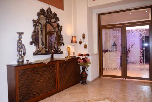 a room with a mirror on the wall next to a door at Paggaio Princess in Nikísiani