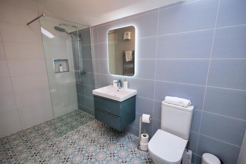 a bathroom with a toilet and a sink and a shower at 9 Parklands Holiday home in Killarney