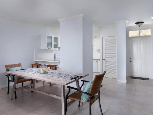 a kitchen and dining room with a table and chairs at Zenbreak Vuemont 245 in Saint Peter