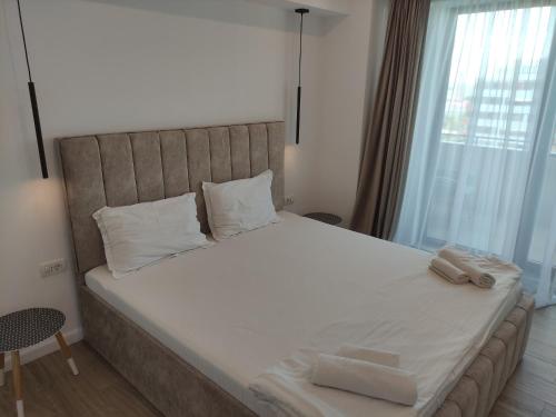 a bed with two towels on it in a bedroom at Aparthotel Black Sea in Constanţa
