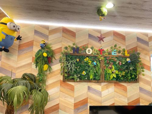 a room filled with plants on a wooden wall at Hotel Jungle fun fun in Osaka