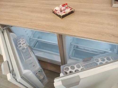 an open drawer in a table with a wooden top at Aparthotel Black Sea in Constanţa