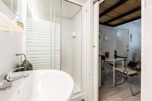 a white bathroom with a sink and a table at Studio 4 Puerta Del Sol in Madrid