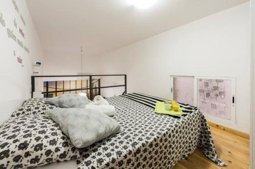 a bedroom with a bed with a black and white comforter at Studio 4 Puerta Del Sol in Madrid