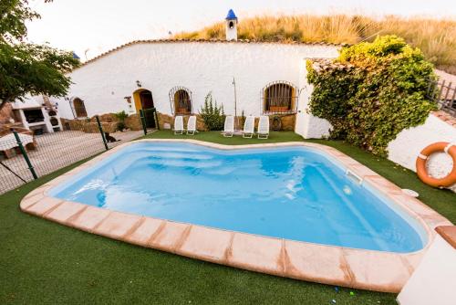 a large swimming pool in the yard of a house at Casas Cueva Cazorla in Hinojares