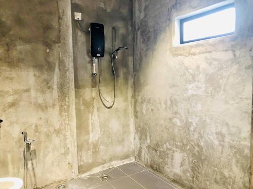 a shower in a bathroom with a window at INS White House Ipoh in Ipoh
