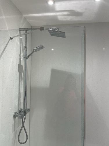 a shower with a glass door in a bathroom at Simpsons in Lairg