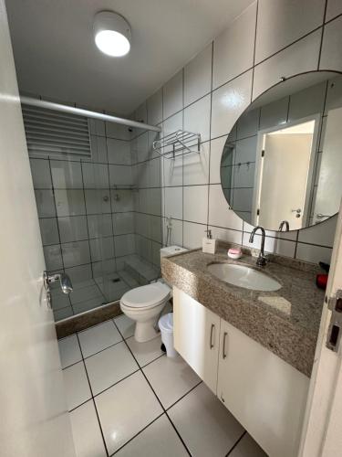 a bathroom with a toilet and a sink and a mirror at Flat no Condomínio Gran Lençóis-Barreirinhas - MA in Barreirinhas