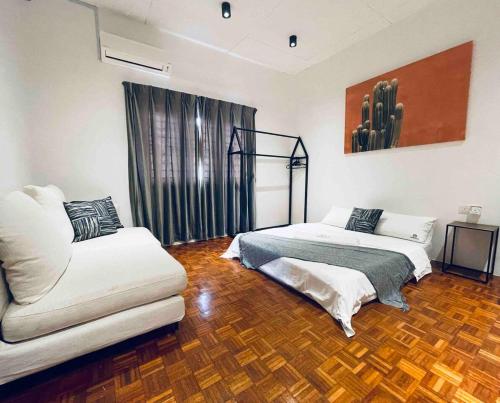 a living room with two beds and a couch at INS White House Ipoh in Ipoh