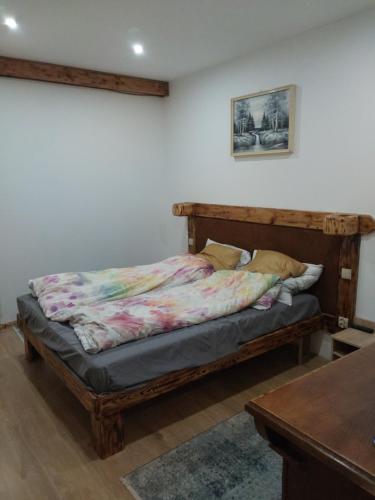 a bed sitting in a room with a table at Wczasy Żywki in Kruklanki